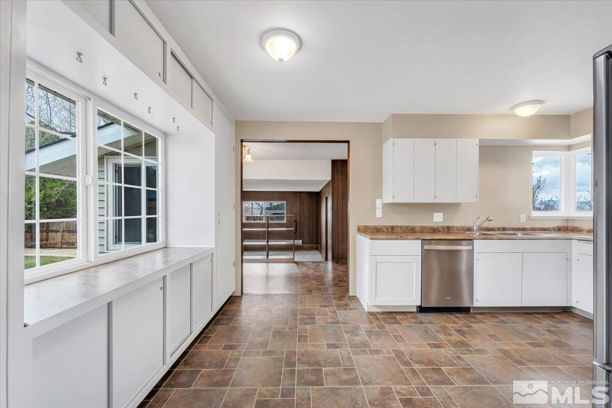 1865 Gridley Avenue Reno, NV 89503 - Photo 8 of 27 a large white kitchen with a stove top oven a sink and dishwasher