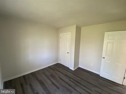 a view of an empty room and wooden floor