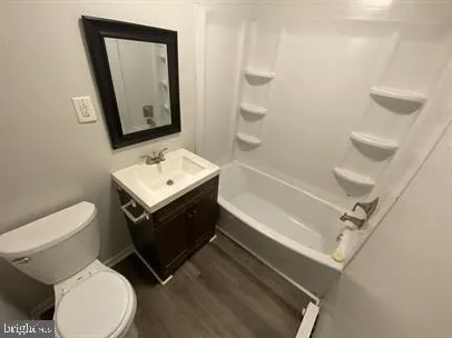 a bathroom with a sink toilet and mirror