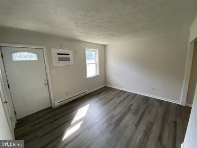 a view of a room with wooden floors and window