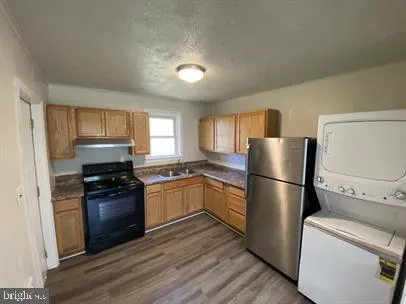 a kitchen with a refrigerator stove and wooden cabinets