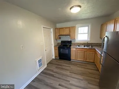 a kitchen with a refrigerator stove and sink