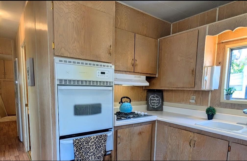 1201 Sycamore Terrace, Unit 148 Sunnyvale, CA 94086 - Photo 23 of 36 a kitchen with stainless steel appliances granite countertop a sink and a refrigerator