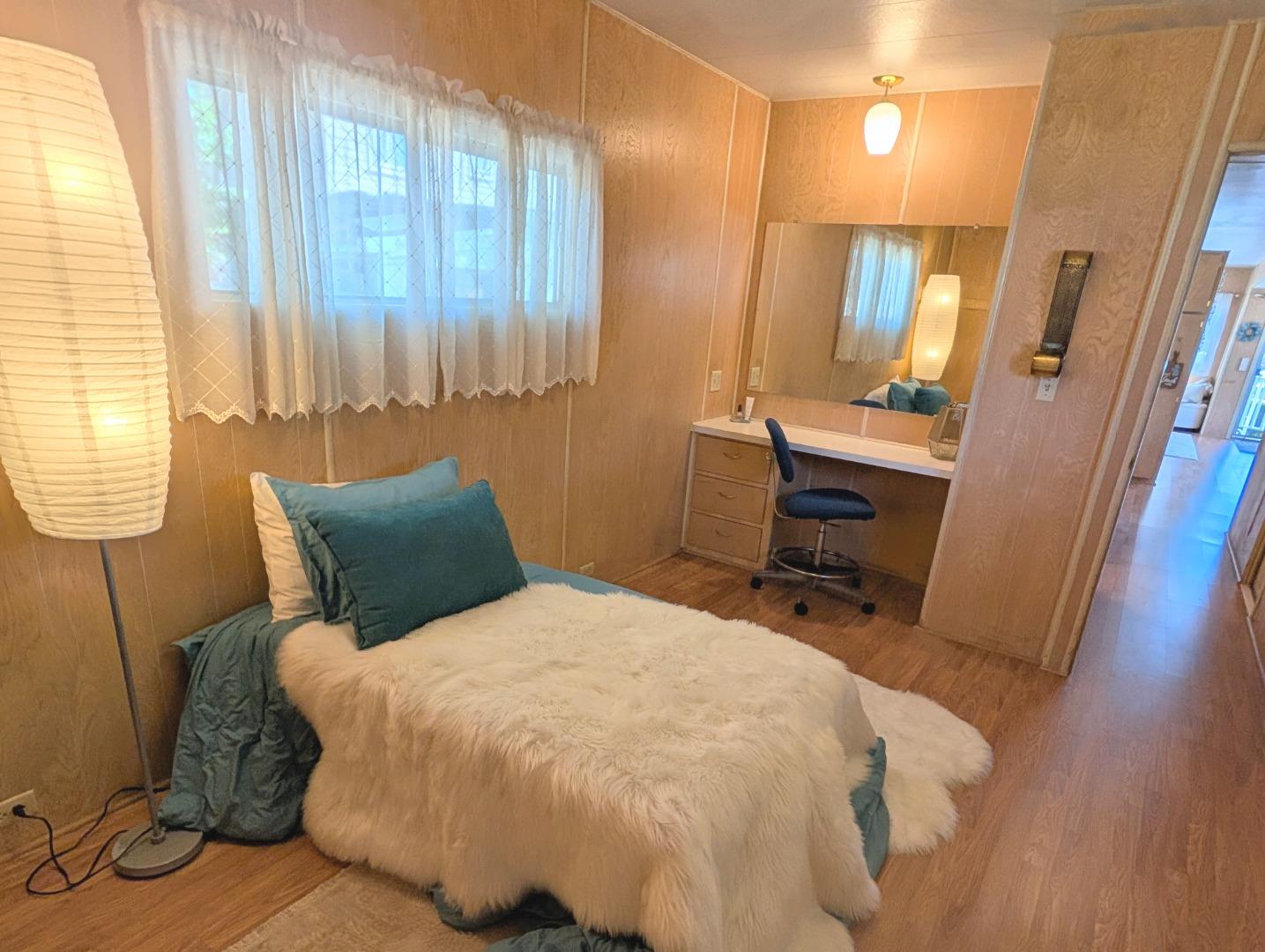 1201 Sycamore Terrace, Unit 148 Sunnyvale, CA 94086 - Photo 27 of 36 a bed sitting in a bedroom next to a window and chair
