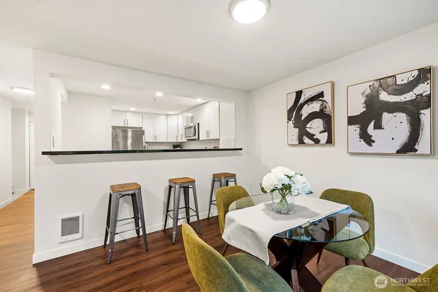 a view of a dining room with furniture and wooden floor