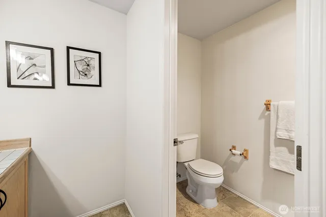 a white toilet sitting next to a bathroom sink