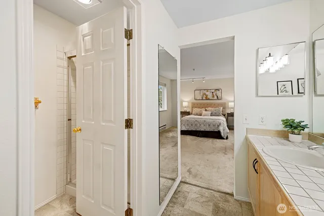 a en suite bathroom with a double vanity sink and shower