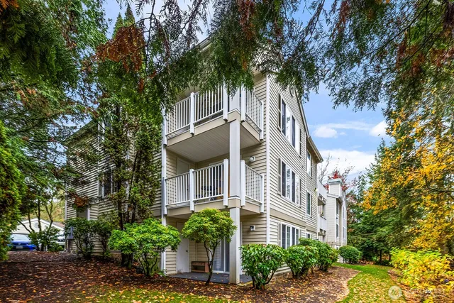 a front view of a house with cars parked