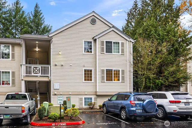 a view of a lake with cars parked