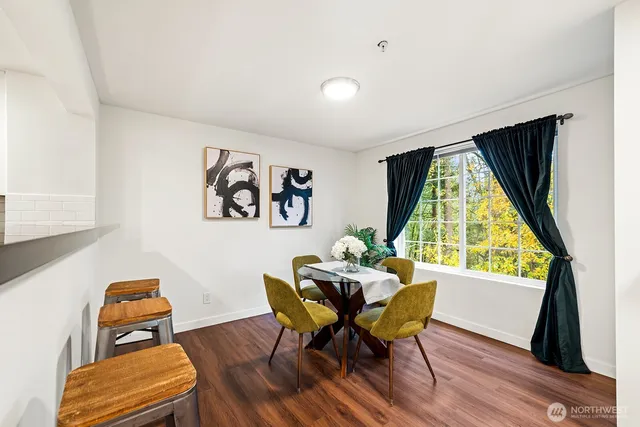 a dining room with furniture and a window
