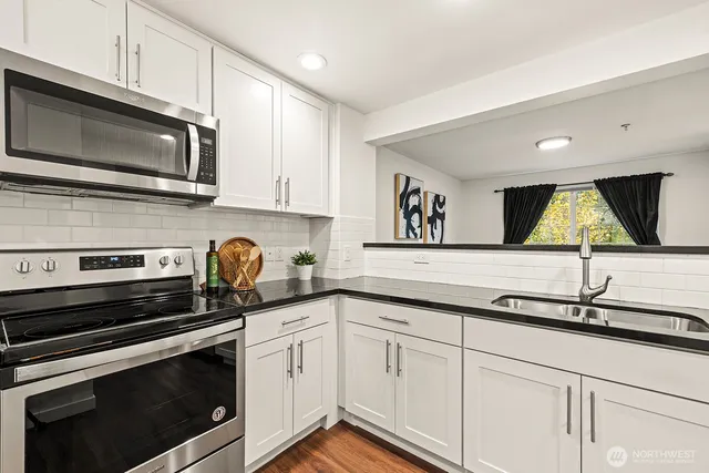 a kitchen with a sink stove and microwave