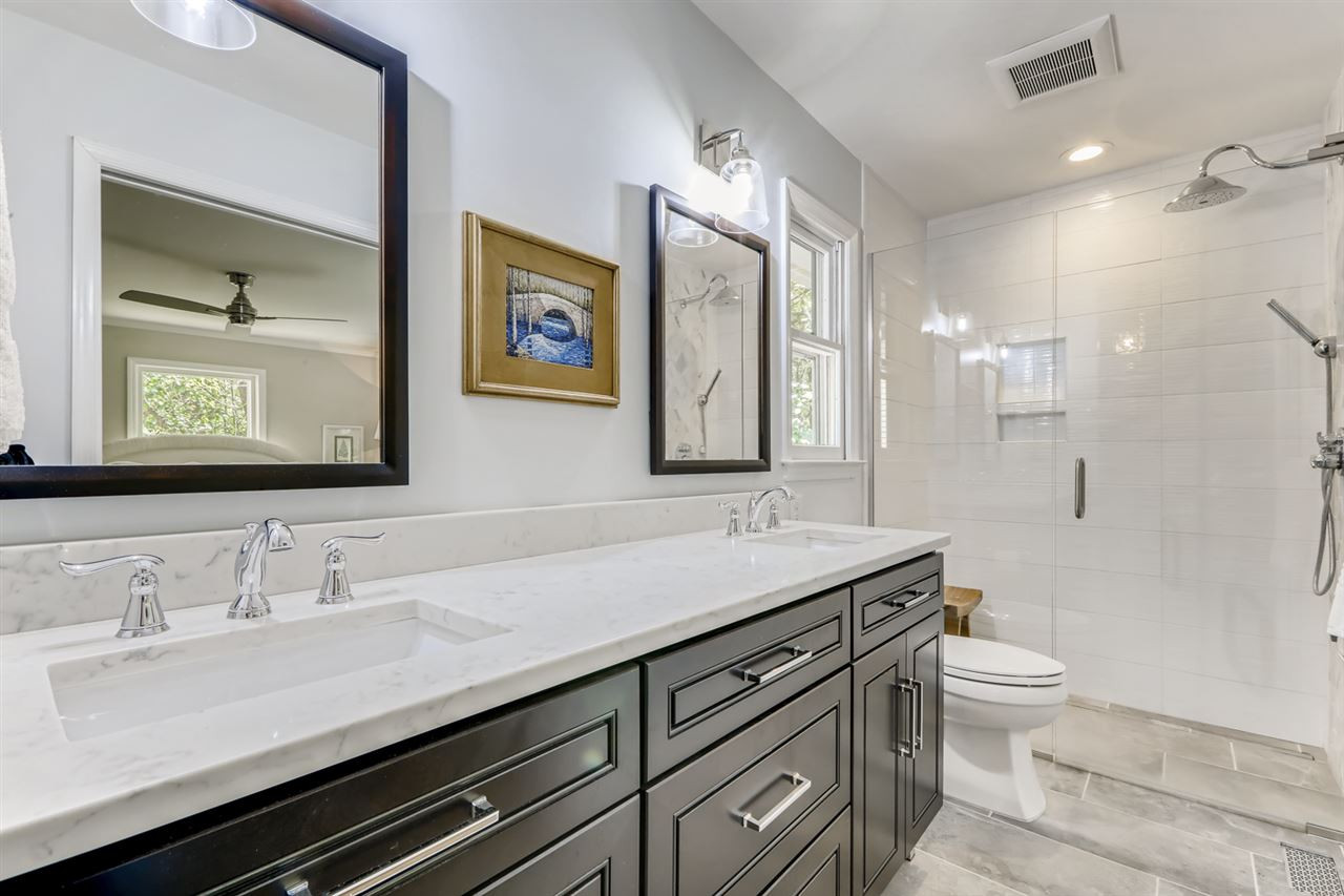 3501 Campbell Road Raleigh, NC 27606 - Photo 18 of 30 Competely renovated Owner Bath with double quartz vanity. Zero-entry shower with rain shower head. Walk in closet with new shelving Renovated Owner Bath