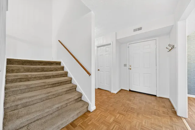 a kitchen with a sink cabinets stainless steel appliances and a window