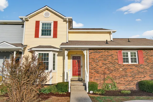 a front view of a residential apartment building with a yard