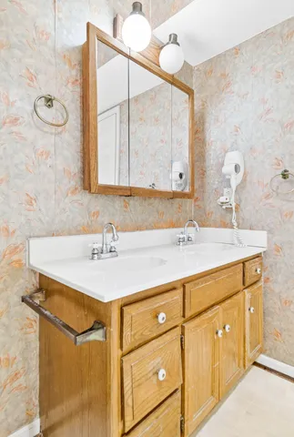a view of empty room with cabinet and fireplace