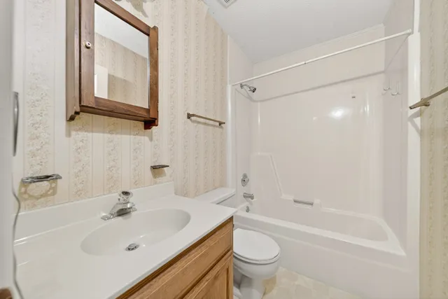 a view of a kitchen with wooden floor and a sink