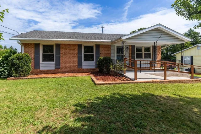 a view of a house with backyard sitting area and porch