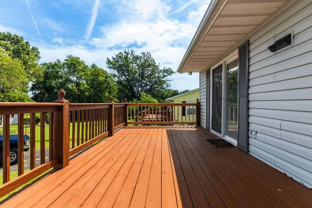 a balcony with wooden floor and fence