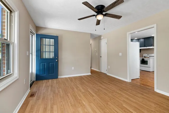 wooden floor in an empty room with a window