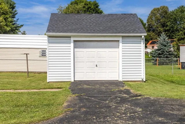 a view of a house with a yard and sitting area