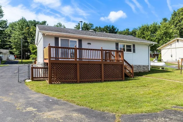 a view of a house with backyard porch and sitting area