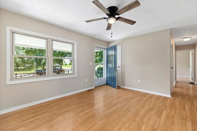 wooden floor in an empty room with a window