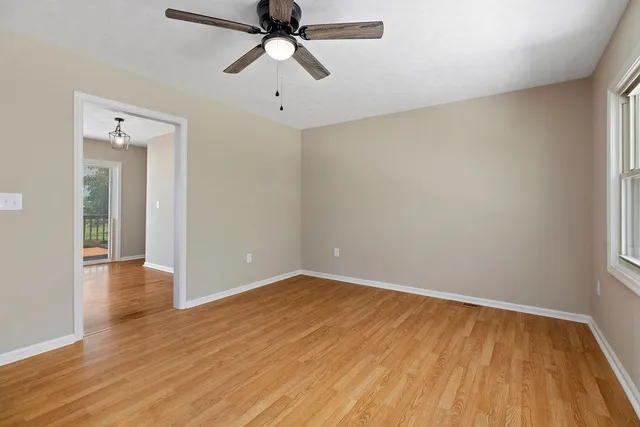 wooden floor in an empty room with a window