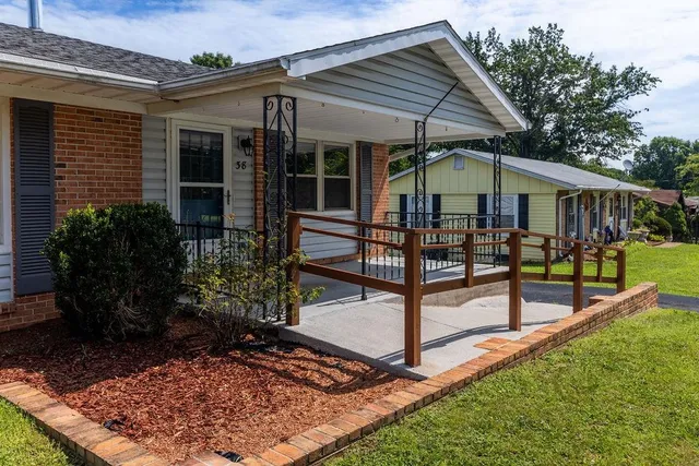 a view of a house with backyard and sitting area