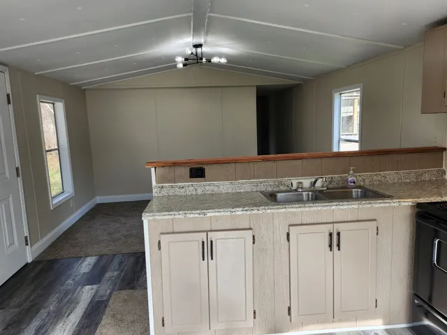 a bathroom with a granite countertop sink a vanity and a large mirror