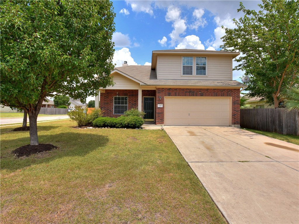 717 Ranchero Road Leander, TX 78641 - Photo 1 of 1 a front view of a house with yard garage and wooden fence