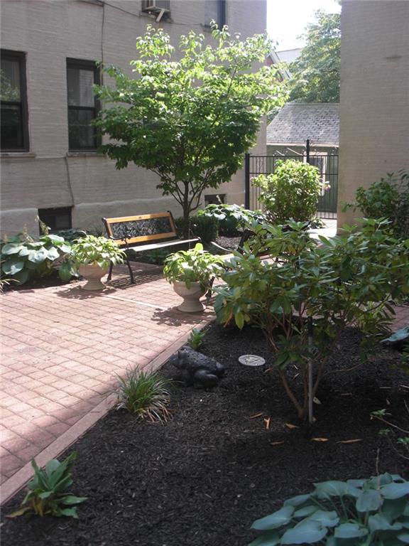 7901 4th Avenue, Unit C21 Brooklyn, NY 11209 - Photo 20 of 21 a backyard of a house with lots of green space