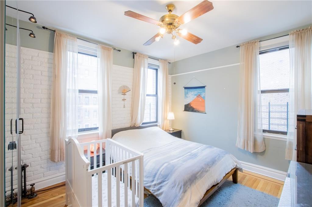 7901 4th Avenue, Unit C21 Brooklyn, NY 11209 - Photo 8 of 21 a bedroom with a bed and a chandelier