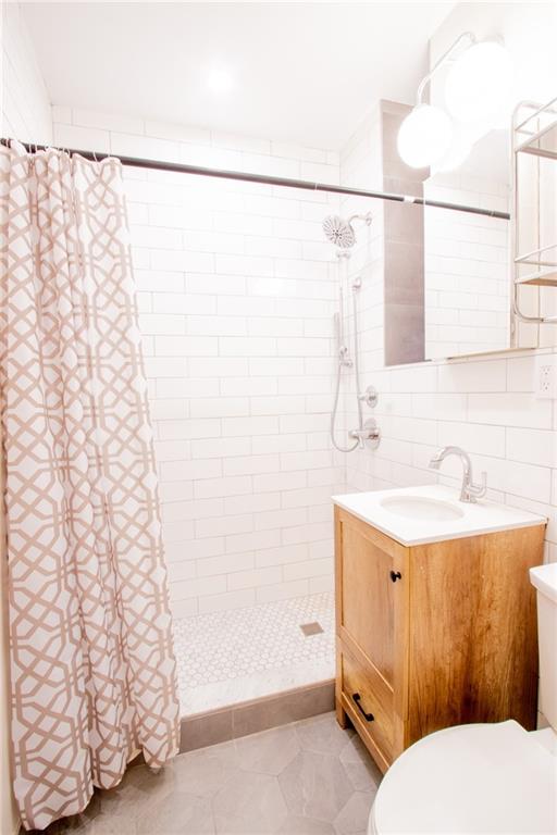 7901 4th Avenue, Unit C21 Brooklyn, NY 11209 - Photo 10 of 21 a bathroom with a sink and a mirror