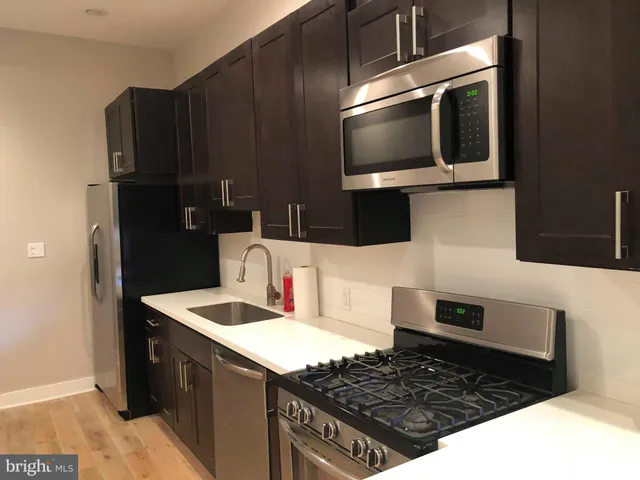 a kitchen with a sink stove and microwave