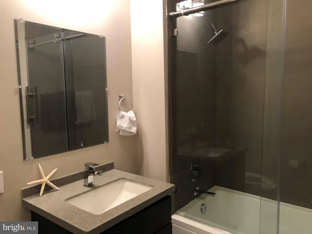 a bathroom with a sink vanity and a mirror