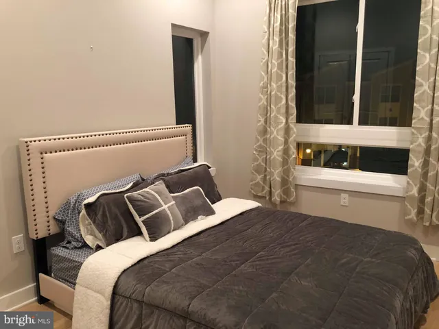 a bedroom with a bed and a window