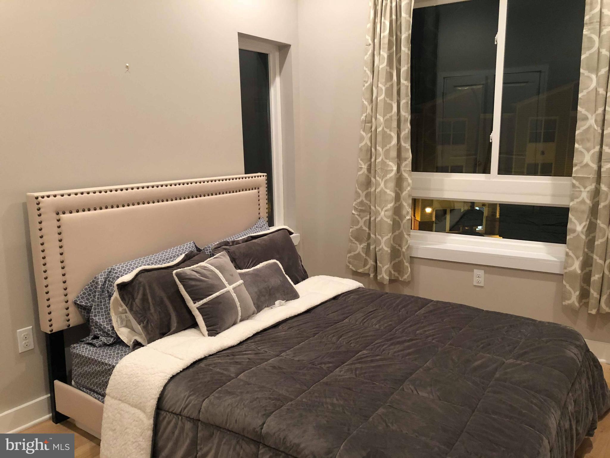 1636 Ridge Avenue, Unit 2 Philadelphia, PA 19130 - Photo 6 of 11 a bedroom with a bed and a window