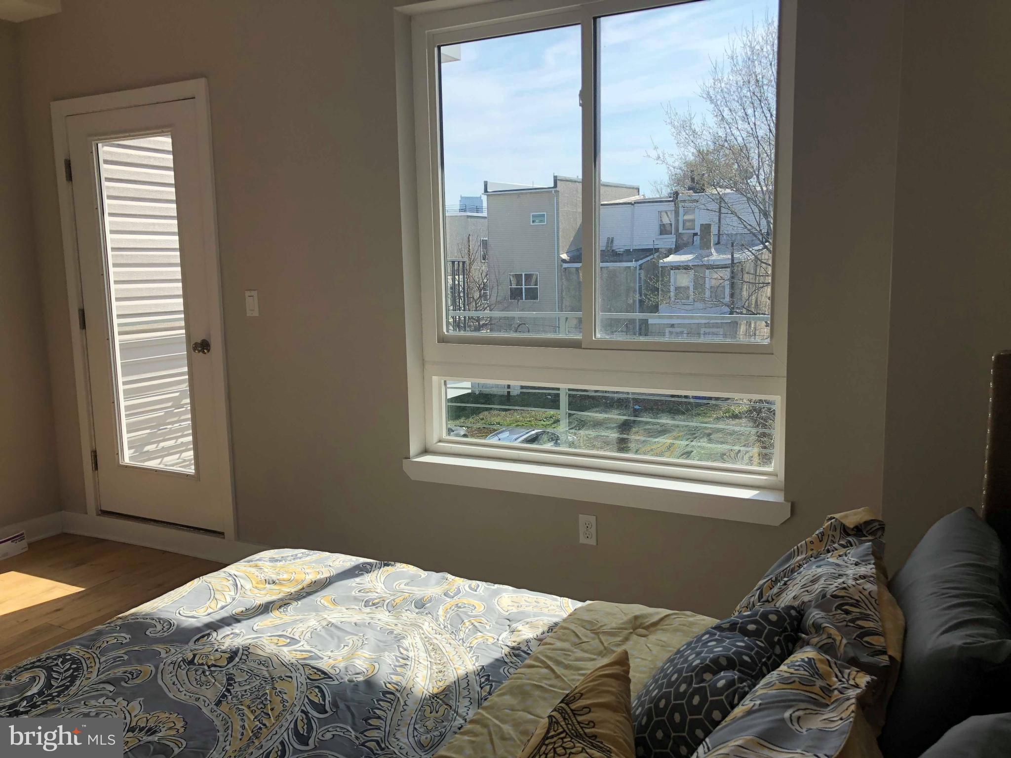 1636 Ridge Avenue, Unit 2 Philadelphia, PA 19130 - Photo 7 of 11 a bedroom with a bed and a window