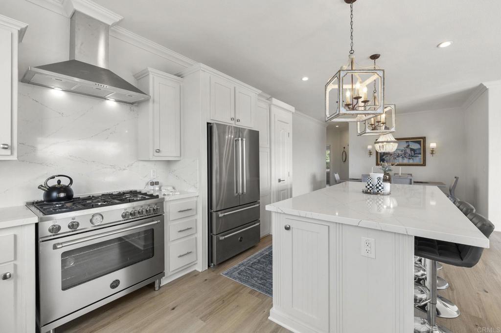 a kitchen with stainless steel appliances a stove a sink and a refrigerator