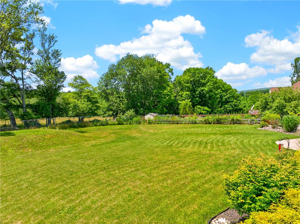 220 Pennbrook Road Stroudsburg, PA 18360 - Photo 53 of 60 Generous green lawn extends to a wooded perimeter, ideal for outdoor enjoyment.