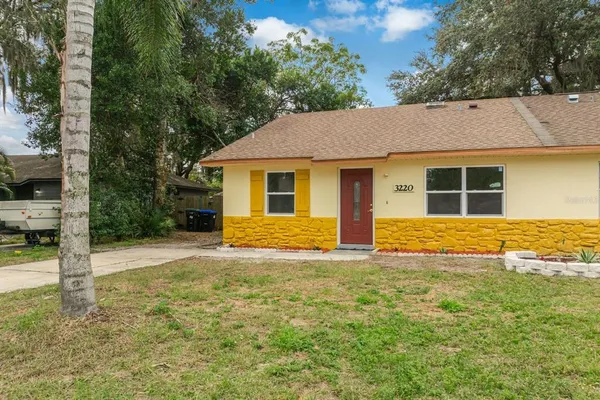 a house that has a big yard with large trees