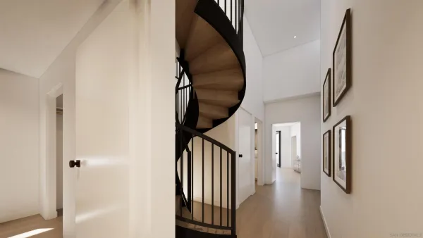 a view of staircase with lots of frames on wall and a window