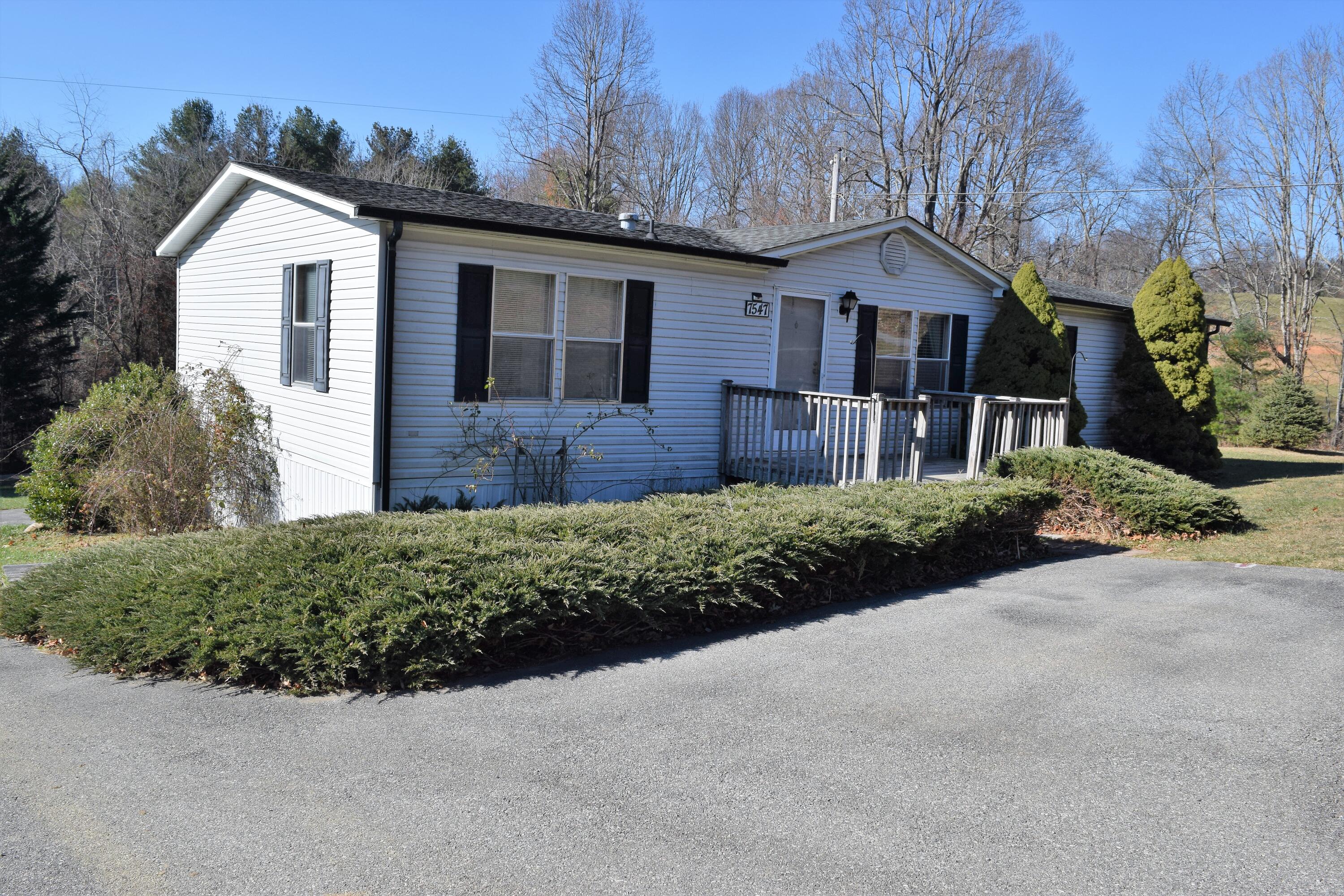 7547 Conner Road Northeast Copper Hill, VA 24079 - Photo 1 of 27 a front view of a house with a yard and garage
