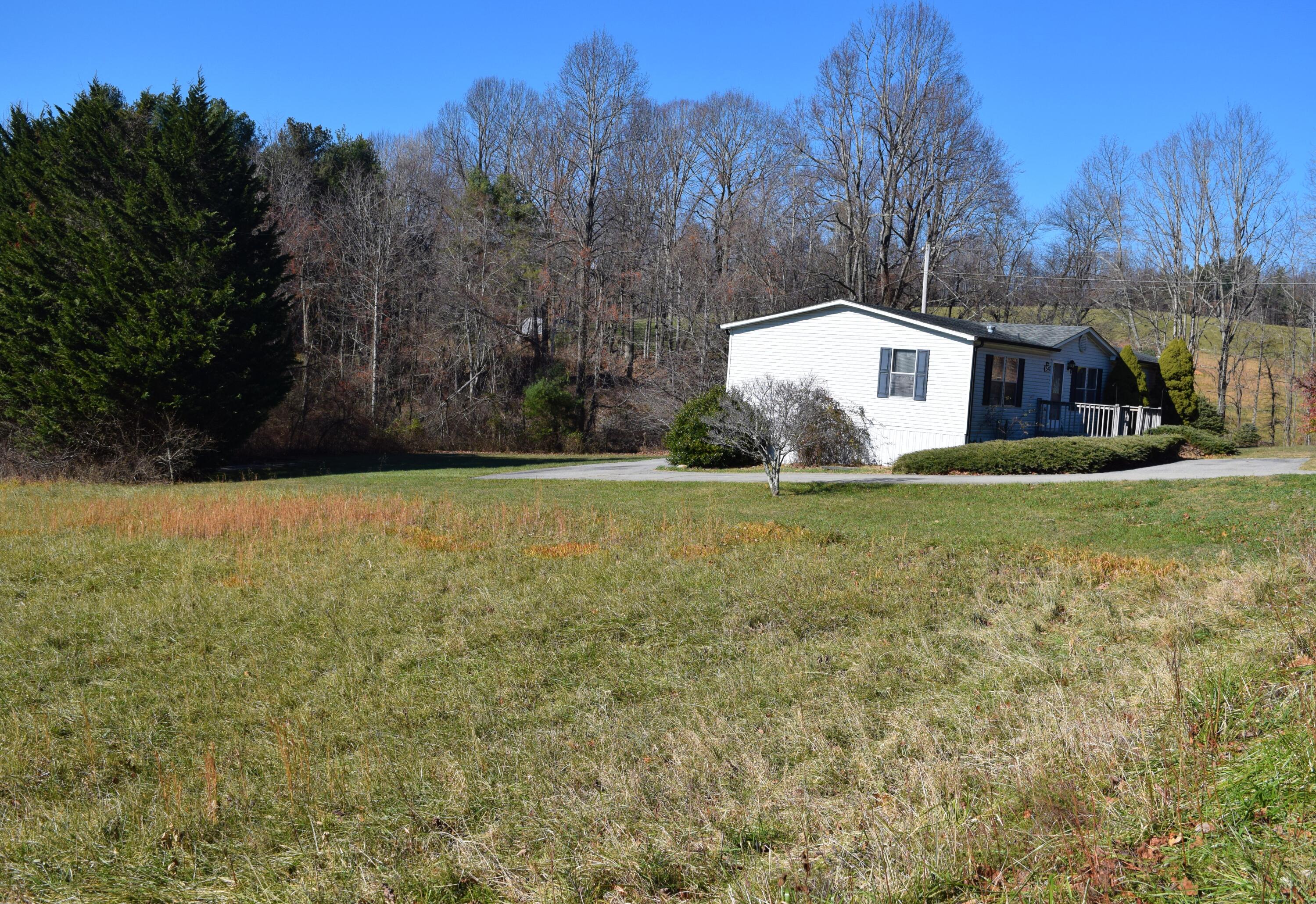 7547 Conner Road Northeast Copper Hill, VA 24079 - Photo 2 of 27 a view of a house with a yard and trees