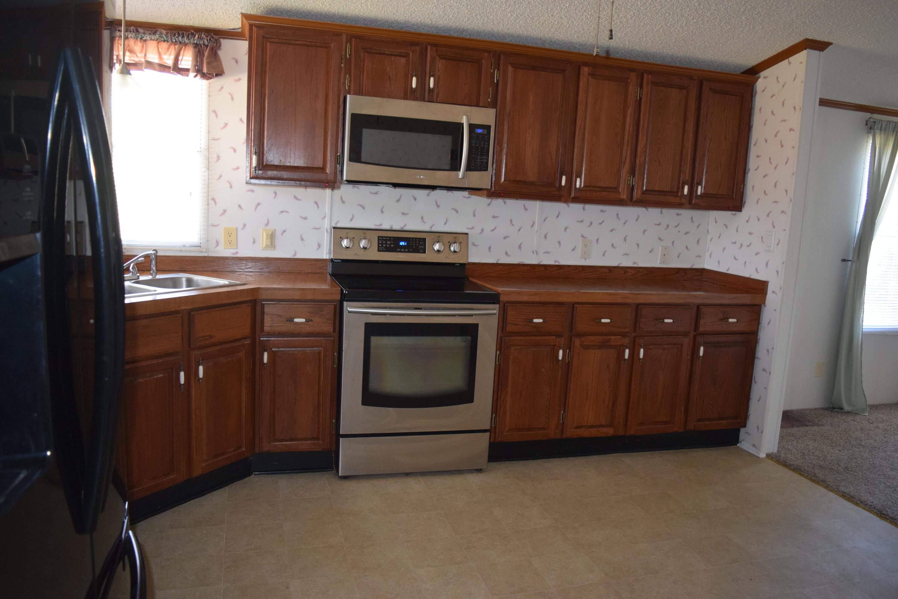 7547 Conner Road Northeast Copper Hill, VA 24079 - Photo 20 of 27 a kitchen with granite countertop wooden cabinets and stainless steel appliances