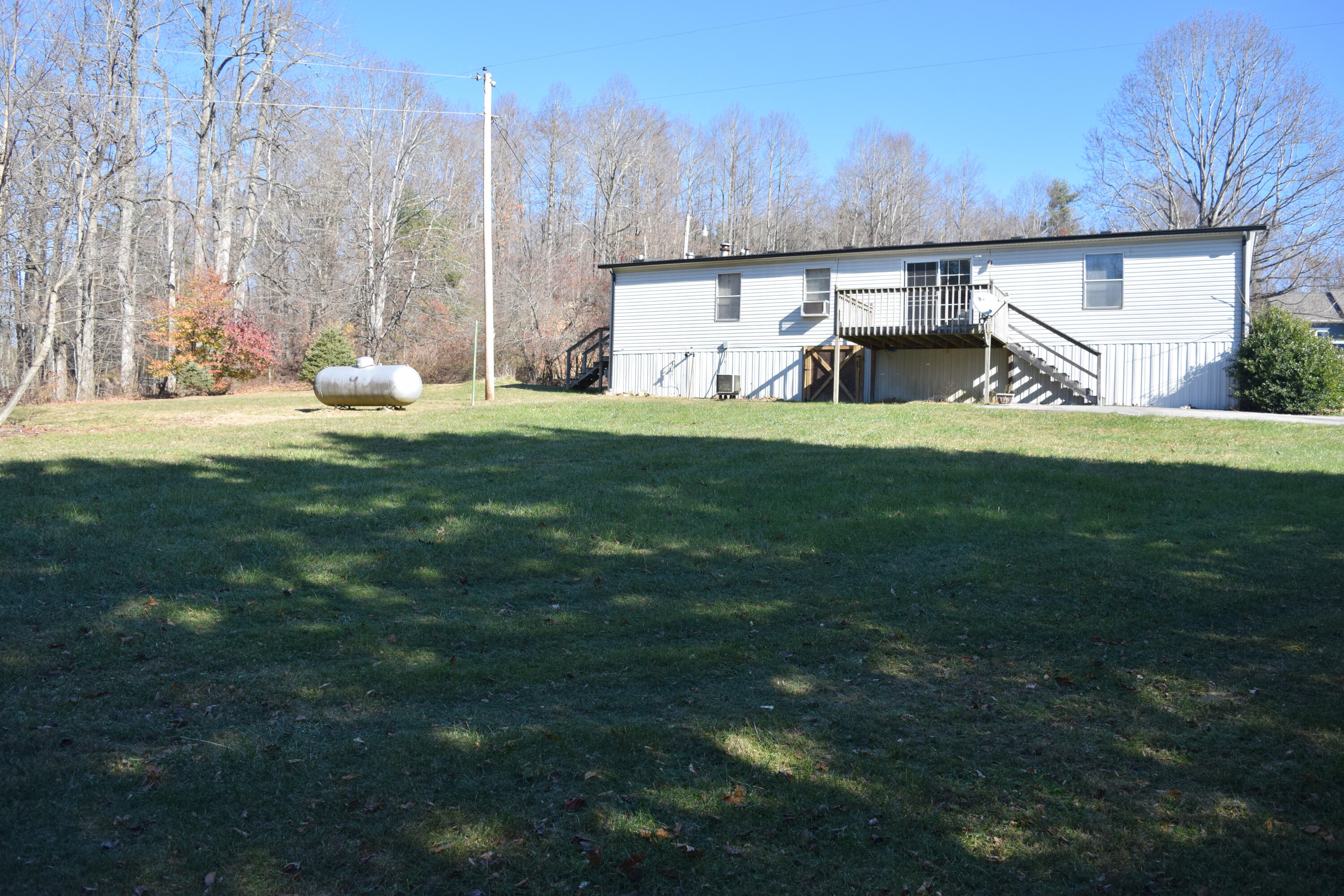 7547 Conner Road Northeast Copper Hill, VA 24079 - Photo 6 of 27 a view of a backyard with large trees