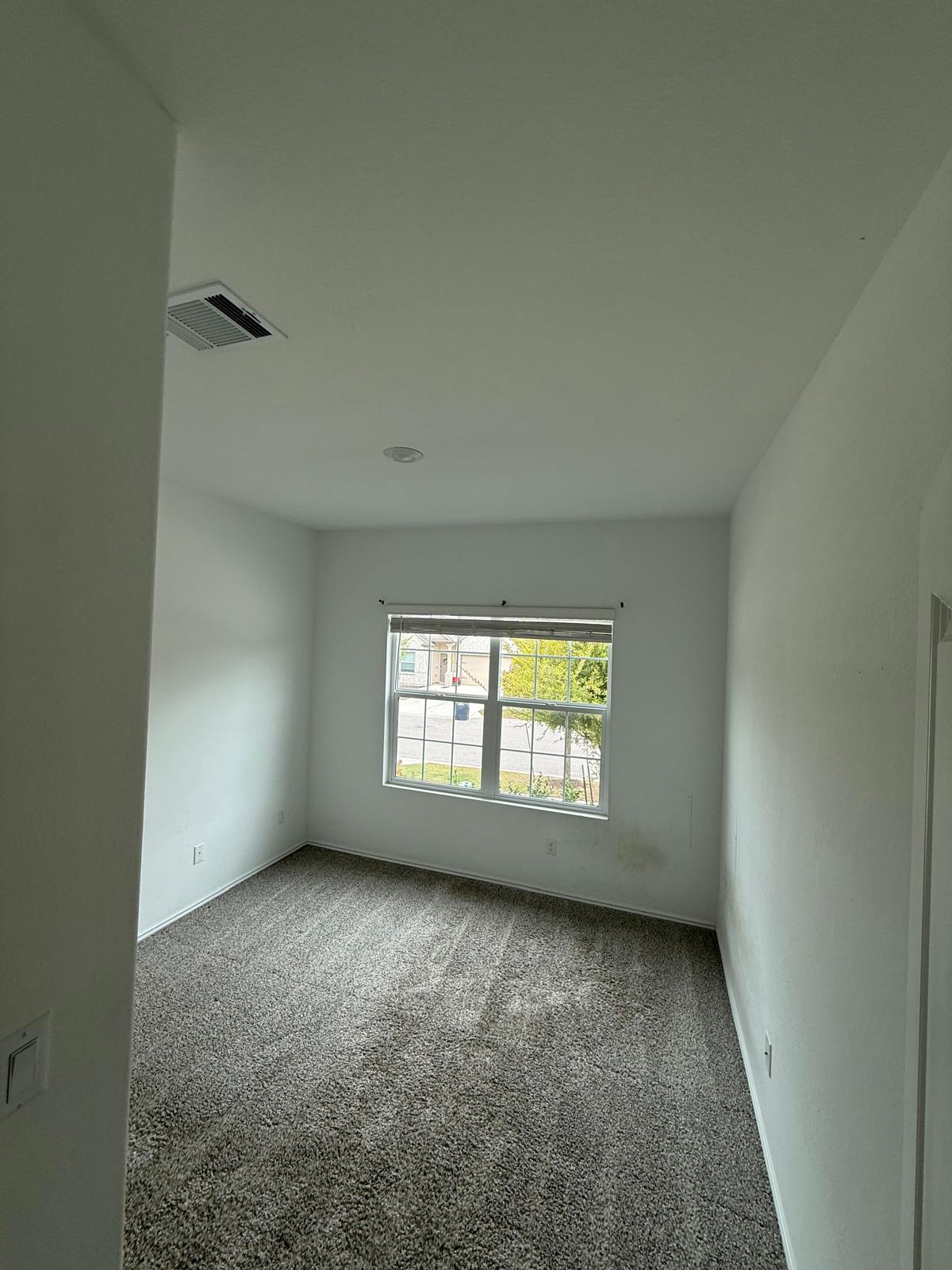 1521 Brueggerhoff Road Leander, TX 78641 - Photo 15 of 15 Plush carpeting and a multi-pane window enhance this versatile, neutrally finished bedroom.