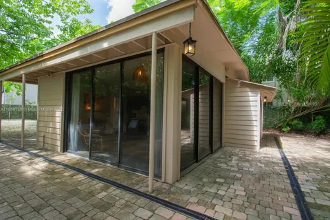 a view of a small house with backyard