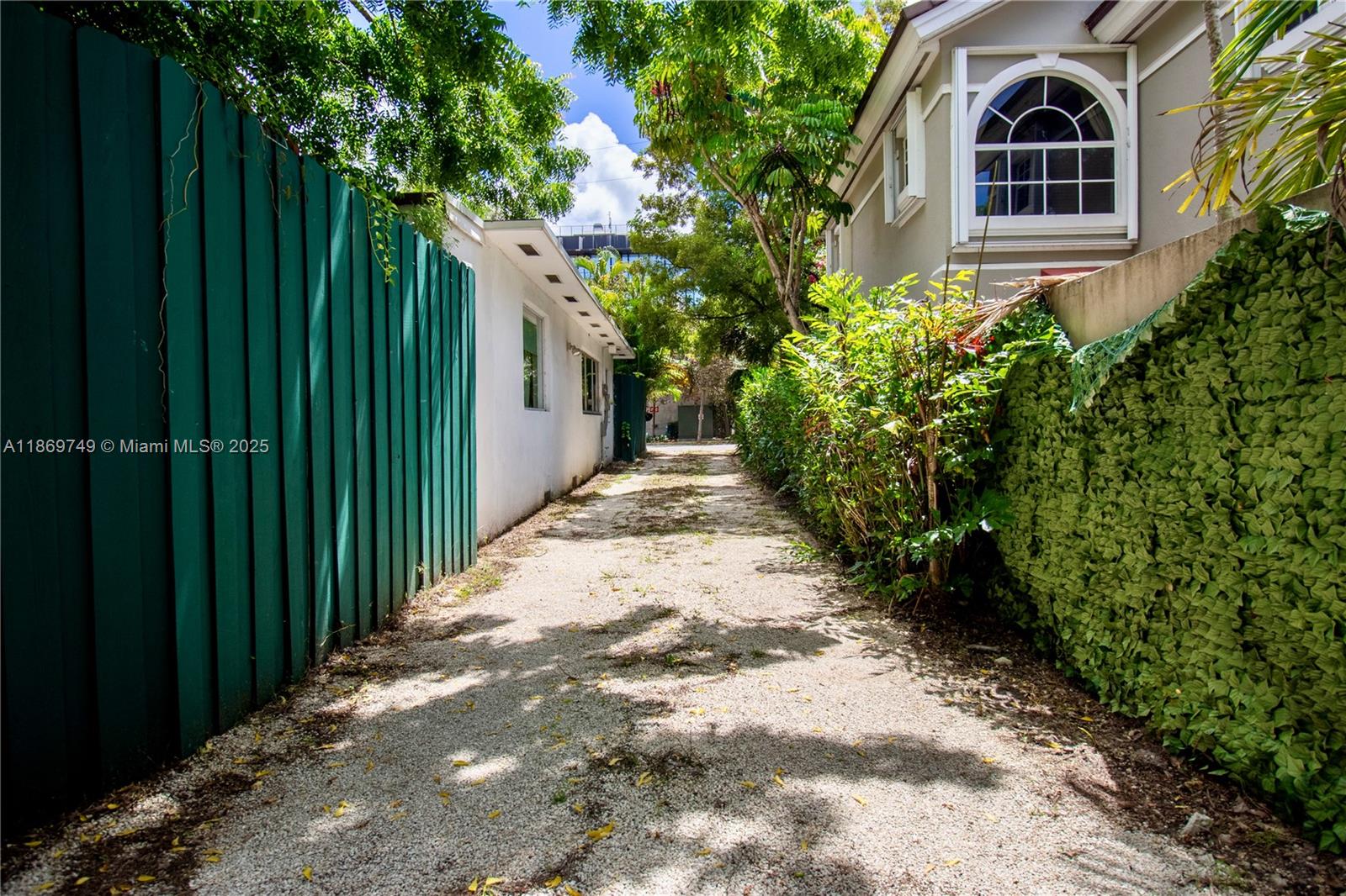 3164 Center Street Miami, FL 33133 - Photo 2 of 15 a view of a pathway both side of house with yard