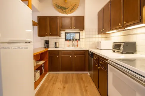 a kitchen with stainless steel appliances a sink stove and cabinets